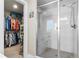 Modern bathroom with glass-enclosed shower and a walk-in closet that offers ample storage space at 16197 Paris Way, Brighton, CO 80602