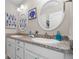 Stylish bathroom features double sinks, granite countertops and decorative accents at 16197 Paris Way, Brighton, CO 80602