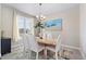 Elegant dining room featuring modern chandelier, neutral decor and a large window at 16197 Paris Way, Brighton, CO 80602