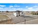 Two-story home with maintained landscaping, gravel perimeter, and fenced yard at 16197 Paris Way, Brighton, CO 80602
