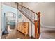Elegant foyer showcasing staircase, wood accents, designer lighting, and seamless flow to the living area at 16197 Paris Way, Brighton, CO 80602