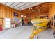 Wood paneled garage featuring a boat and motorcycle at 16197 Paris Way, Brighton, CO 80602