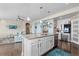 Gourmet kitchen featuring granite countertops, white cabinets, stainless steel appliances, and a large island with bar seating at 16197 Paris Way, Brighton, CO 80602
