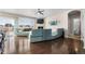 Spacious living room with a fireplace, large windows, hardwood floors, and stylish furnishings at 16197 Paris Way, Brighton, CO 80602