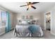 Comfortable bedroom with a fan, plush bedding, and serene decor for a restful ambiance at 16197 Paris Way, Brighton, CO 80602