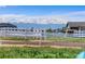 Expansive views of the snow capped mountains and white fences across the property at 16197 Paris Way, Brighton, CO 80602