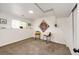 Finished basement area with neutral carpeting, ample lighting, and decorative wall art at 978 S Salida St, Aurora, CO 80017