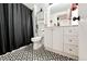 Stylish bathroom featuring a black shower curtain and eye-catching tile flooring at 978 S Salida St, Aurora, CO 80017