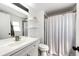 Bright bathroom with a shower/tub combo, white vanity, and stylish decor at 978 S Salida St, Aurora, CO 80017