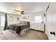 Bright bedroom with a ceiling fan, dressers, carpet and a comfortably sized bed at 978 S Salida St, Aurora, CO 80017