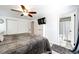 Comfortable bedroom featuring a TV, ceiling fan, and an open doorway to an ensuite bathroom at 978 S Salida St, Aurora, CO 80017