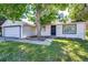 Exterior view showcasing a well-kept lawn, complemented by a sturdy front door and neat landscaping at 978 S Salida St, Aurora, CO 80017