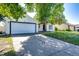 Exterior view of a home with a two-car garage and a large driveway, surrounded by lush greenery at 978 S Salida St, Aurora, CO 80017
