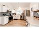 Bright kitchen features stainless appliances, white cabinetry, and a modern gray backsplash at 978 S Salida St, Aurora, CO 80017