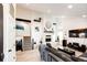 Bright living room with a fireplace, vaulted ceiling, and stairs leading to the second floor at 978 S Salida St, Aurora, CO 80017