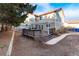 The rear elevation shows a tan home featuring a wooden deck and a winding brick sidewalk at 10645 Clarkeville Way, Parker, CO 80134