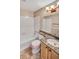 Bathroom featuring a shower-tub combo, vanity with granite countertop, and tile flooring at 10645 Clarkeville Way, Parker, CO 80134