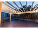 A rear patio featuring wooden planks, a dark wood railing, and trellises above at 10645 Clarkeville Way, Parker, CO 80134