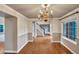 Bright dining room with hardwood floors, chandelier, and views of the staircase at 10645 Clarkeville Way, Parker, CO 80134