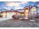 Inviting two-story home featuring an attached three-car garage and a striking brick archway entrance at 10645 Clarkeville Way, Parker, CO 80134