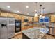 Modern kitchen featuring stainless steel appliances, a granite island, and sleek cabinetry at 10645 Clarkeville Way, Parker, CO 80134