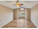 Spacious living room featuring hardwood floors, large windows, and a ceiling fan at 10645 Clarkeville Way, Parker, CO 80134