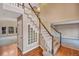 Elegant staircase with carpeted steps, wood handrail, and decorative glass block window at 10645 Clarkeville Way, Parker, CO 80134