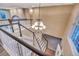 Carpeted staircase with dark railings, white trim and banister leading down from the second floor at 10645 Clarkeville Way, Parker, CO 80134