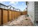 Charming backyard with stone and rock landscaping with wood fence and patio at 5050 Akron St, Denver, CO 80238