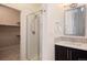 Bathroom features a glass-enclosed shower, modern vanity, and ample storage space at 5050 Akron St, Denver, CO 80238