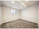 Cozy bedroom featuring neutral paint, plush carpet, and a window for natural light at 5050 Akron St, Denver, CO 80238