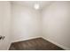 Cozy bedroom with neutral carpet, modern light fixture, and fresh white paint at 5050 Akron St, Denver, CO 80238