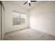 Clean bedroom featuring neutral paint, plush carpet, and window for ample natural lighting at 5050 Akron St, Denver, CO 80238