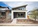 Contemporary home with modern architecture, covered porch, and attractive landscaping at 5050 Akron St, Denver, CO 80238