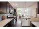 Gourmet kitchen featuring stainless steel appliances, large island, and open layout to the living spaces at 5050 Akron St, Denver, CO 80238