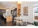 Bright kitchen featuring island with barstools and open views to the dining and living areas at 5050 Akron St, Denver, CO 80238