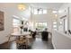 Spacious living room with vaulted ceilings, fireplace, and large windows offering ample natural light at 5050 Akron St, Denver, CO 80238