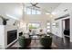 Bright living room with vaulted ceilings, large windows, and a cozy fireplace, creating an inviting space at 5050 Akron St, Denver, CO 80238