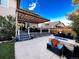 Landscaped backyard featuring a stone patio, dining area, and built-in fire pit at 15468 W 50Th Pl, Golden, CO 80403