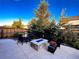 Fenced-in yard with patio seating and a modern fire pit, ideal for outdoor relaxation at 15468 W 50Th Pl, Golden, CO 80403