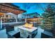 Backyard space with a built-in fire pit surrounded by comfortable seating at 15468 W 50Th Pl, Golden, CO 80403