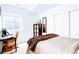 Bright bedroom featuring neutral colors, a desk area, and natural light at 15468 W 50Th Pl, Golden, CO 80403