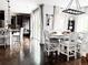 Stylish dining area with hardwood floors and modern lighting, open to kitchen and breakfast bar at 15468 W 50Th Pl, Golden, CO 80403