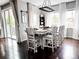 Bright dining room featuring hardwood floors, large windows, and a modern chandelier at 15468 W 50Th Pl, Golden, CO 80403