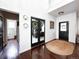 Inviting foyer with dark wood floors, high ceilings, decorative lighting, and front door at 15468 W 50Th Pl, Golden, CO 80403
