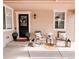 Inviting front porch with seating, decor, and a black door and window trim for stylish curb appeal at 15468 W 50Th Pl, Golden, CO 80403