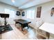 Finished game room with ping pong table and exercise bike at 15468 W 50Th Pl, Golden, CO 80403