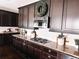 Kitchen featuring dark cabinetry, granite countertops, stainless steel gas range, and a wreath at 15468 W 50Th Pl, Golden, CO 80403