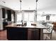 Spacious kitchen with dark cabinets, granite counters, stainless appliances, and pendant lighting at 15468 W 50Th Pl, Golden, CO 80403