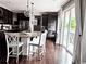 Kitchen featuring dark wood cabinets, stainless steel appliances, granite countertops, and bar seating at 15468 W 50Th Pl, Golden, CO 80403